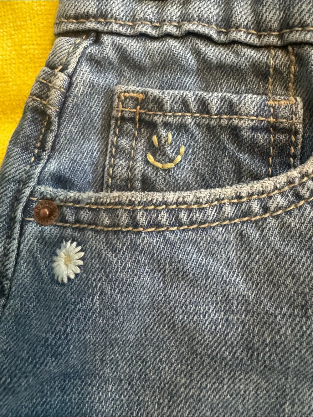 Old Navy Blue Denim Cutoff Shorts with Embroidered Smile and Daisies